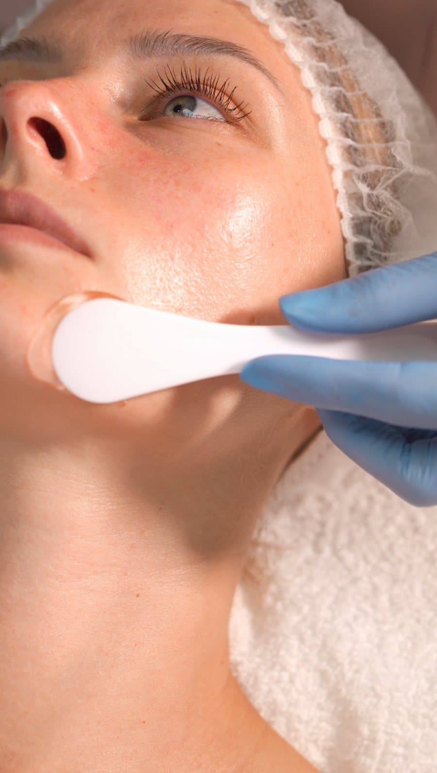 Beauty film still: facial treatment with a white handpiece